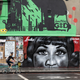 A woman cycles past a piece of street art by artist, Jules Muck in collaboration with Global Street Art, paying tribute to the late Aretha Franklin in the East London Shoreditch area on Aug. 23, 2018, in London, England.